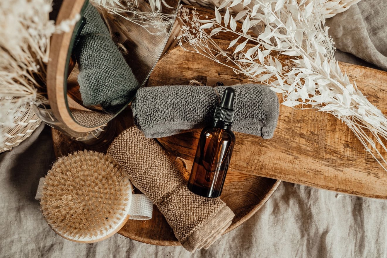 Wellness supplies arranged on a wooden tray in the studio